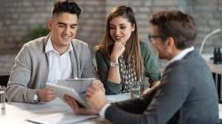 Young Hispanic couple working with financial advisor